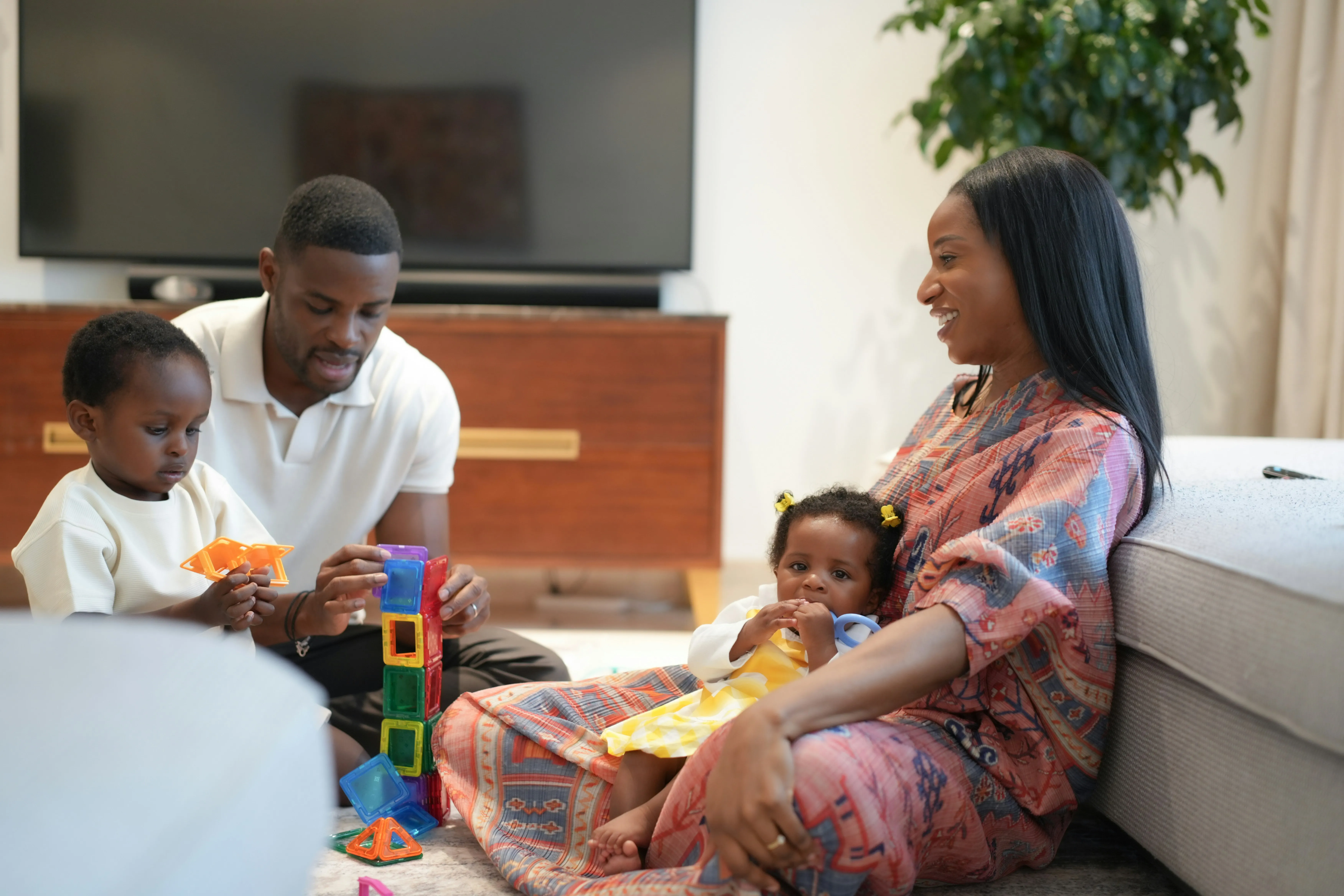mother and father engaging with two children