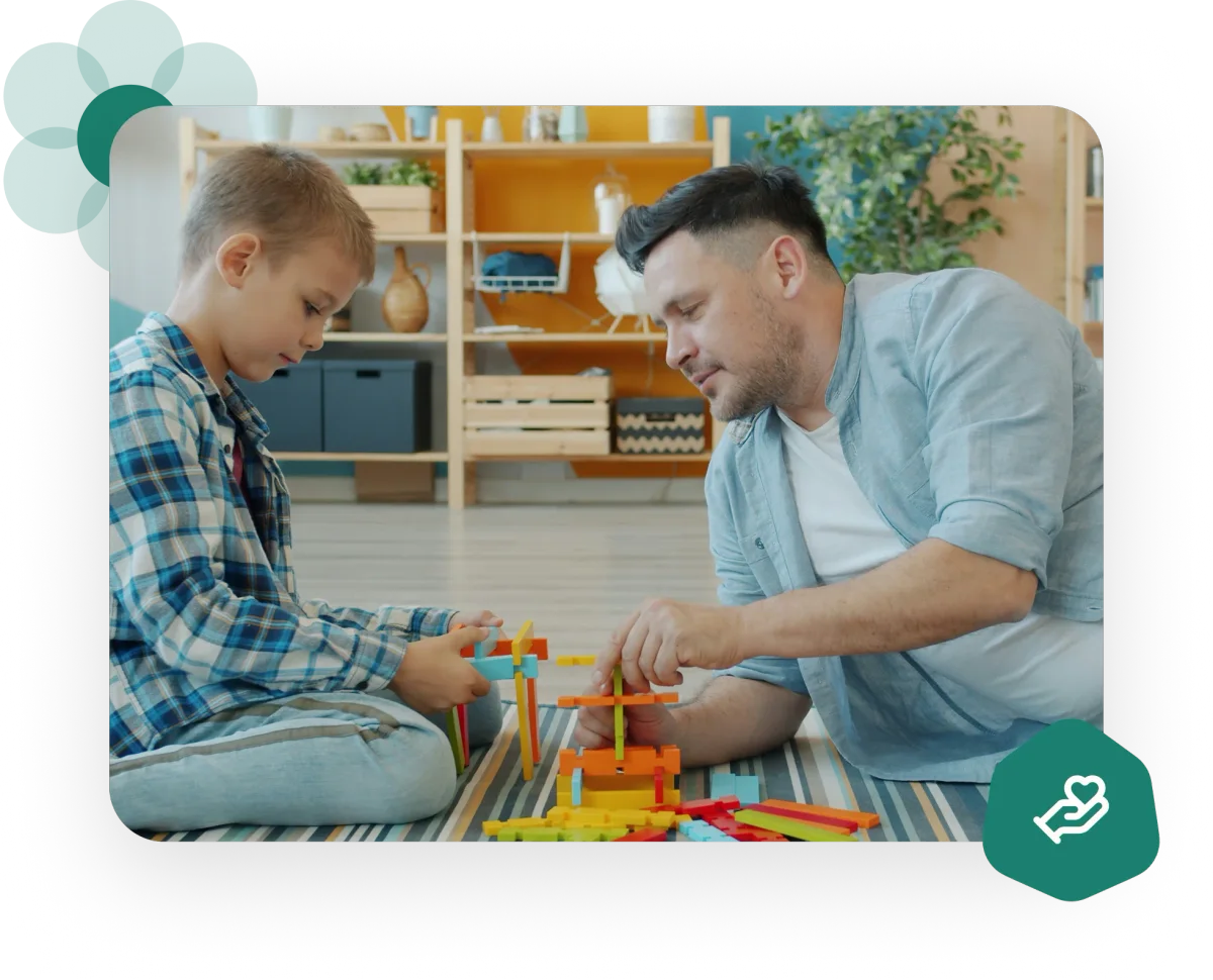 father playing with child on the floor